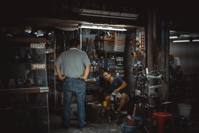 Mechanic working on a car engine in a garage